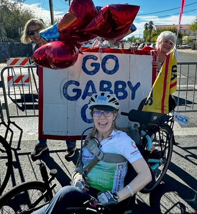 Gabby Giffords on a recumbent trike during her recovery