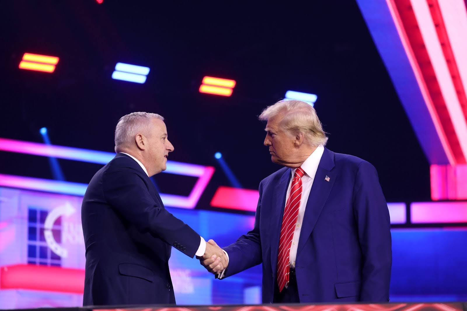 Michael Whatley and Donald Trump shaking hands